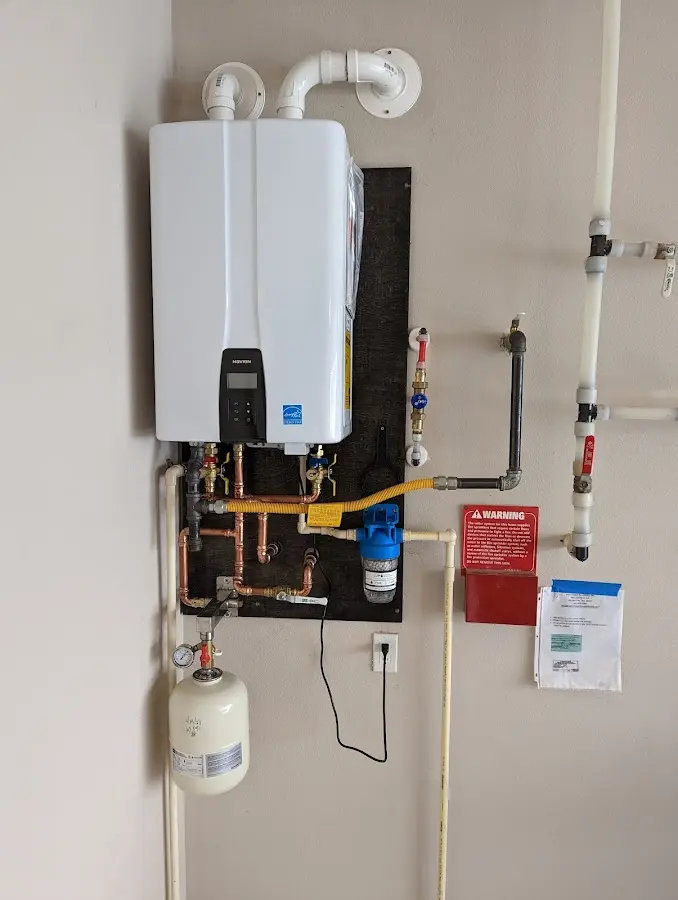 Professional plumber installing copper piping in a West Miami home